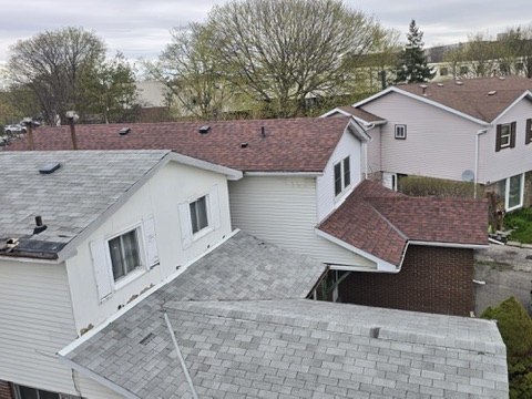 Roofing crew working from ladders on residential replacement by 905 Roofing Inc. in Durham Region and the GTA