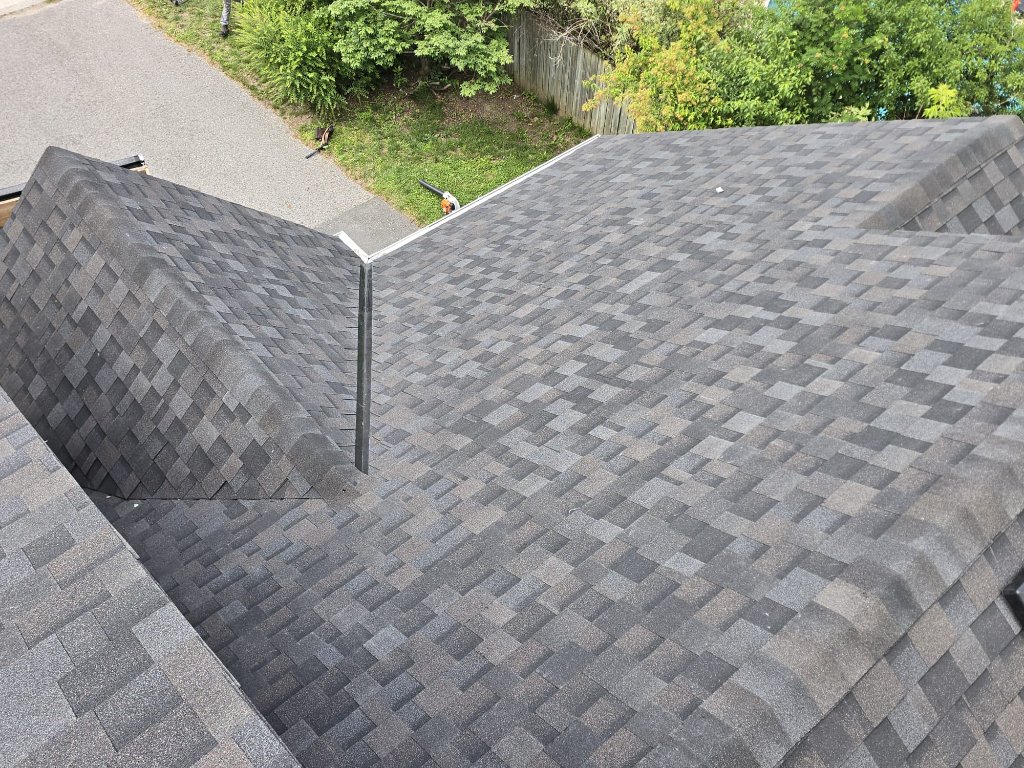 Completed grey architectural shingle roof replacement with clean valley flashing and ridge detail on a residential home by 905 Roofing Inc. in Durham Region and the GTA