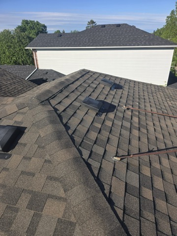 Clean shingle edge and flashing detail by 905 Roofing Inc.
