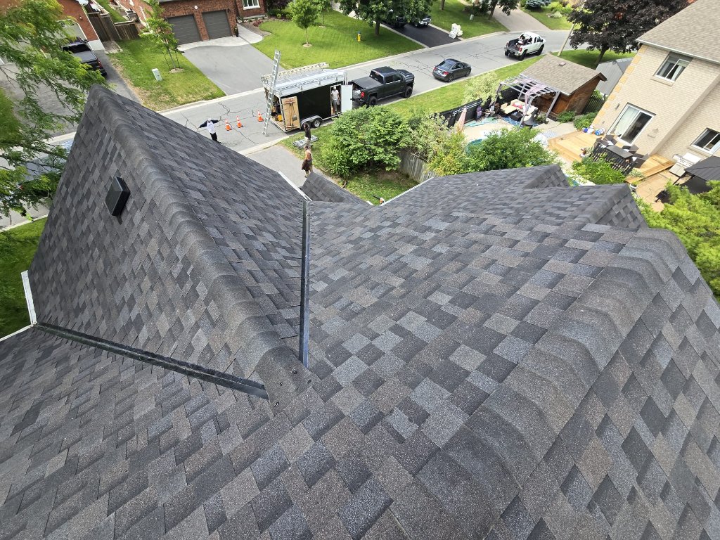 Close view of new architectural shingles with clean valley metal detail and ridge cap installation by 905 Roofing Inc. in Durham Region and the GTA