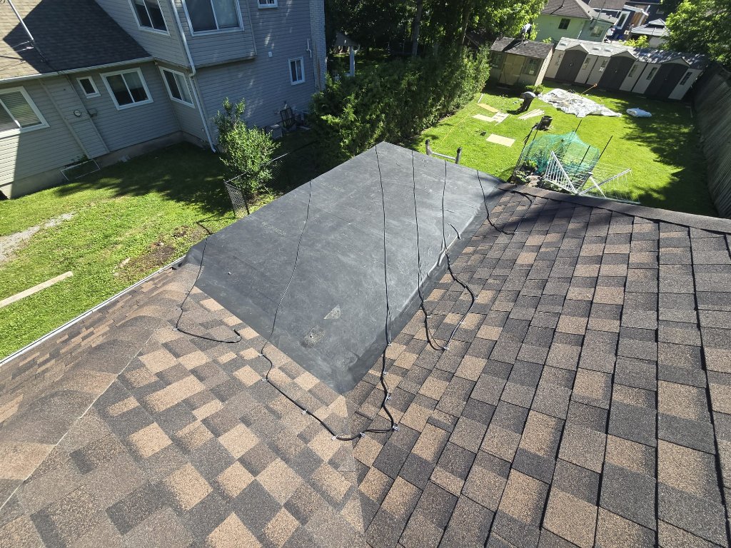 EPDM flat roof membrane installed on a residential low-slope roof section beside architectural shingles by 905 Roofing Inc. in Durham Region and the GTA