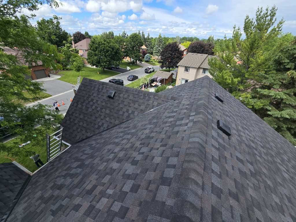 Wide roofline view of completed grey asphalt shingle roof replacement in a residential neighbourhood by 905 Roofing Inc. in Durham Region and the GTA